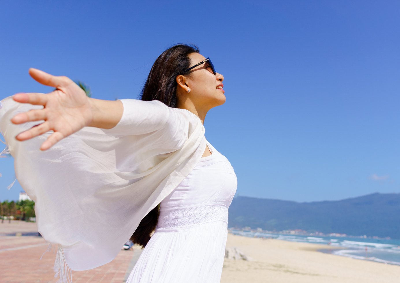 Happy young women standing on the beach